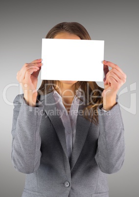 Business woman with blank card over face against grey background