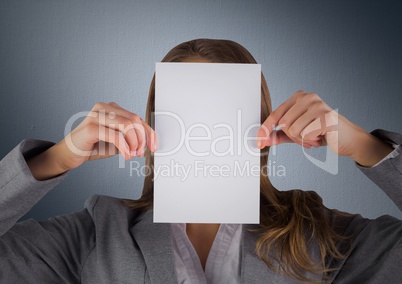 Business woman with blank card over face against navy background