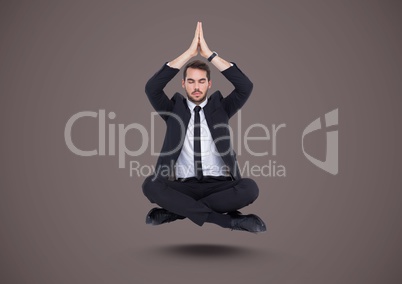 Businessman Meditating floating against brown background