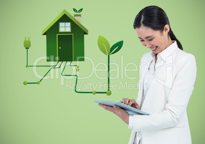 Woman with tablet and green house graphic against green background