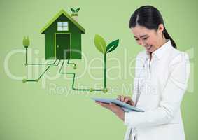 Woman with tablet and green house graphic against green background