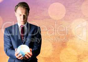 Man with globe against map with bokeh