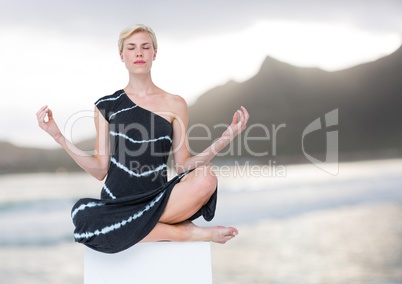Woman Meditating peaceful by mountains