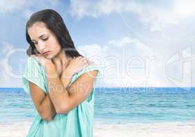 Sad young woman against beach sea
