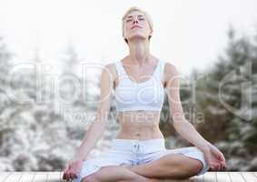 Woman Meditating in snow forest