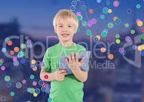 Boy with tablet against Night city with connectors