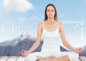 Woman Meditating by mountain