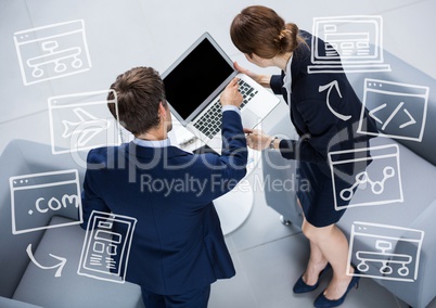 Overhead of business man and woman with white business doodles