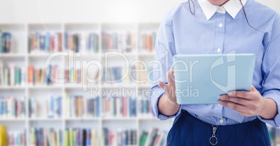 Womans hands on tablet in Library