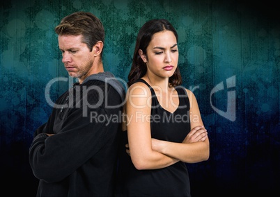 Sad dark couple back to back against dark background