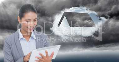 Business woman behind flare with tablet and cloud with roof against stormy sky