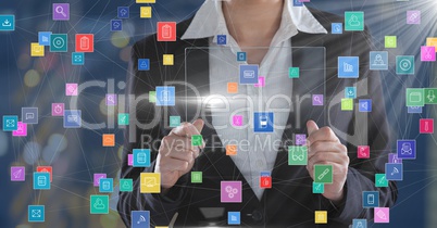 Business woman holding futuristic device surrounded by colorful icons