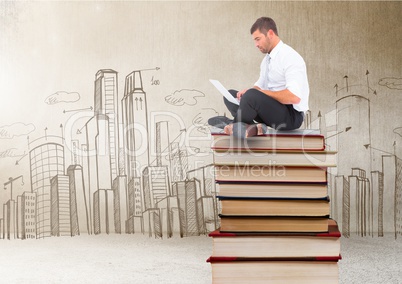 Businessman sitting on Books stacked by city drawings