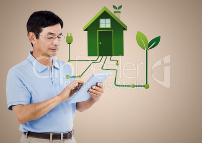 Man with tablet and green house graphic against cream background