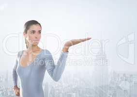 Woman with open palm hand in front of city