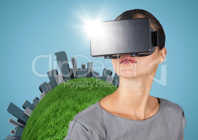 Woman in VR with globe and buildings against blue background