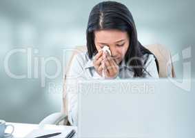 Sad woman crying on laptop with bright background