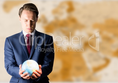 Man with globe against brown blurry map
