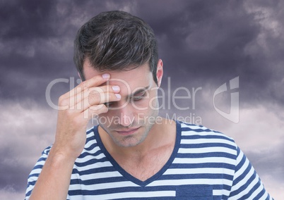 Depressed stressed man against dark clouds