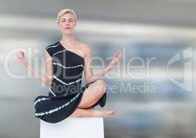 Woman Meditating peaceful against motion blur background