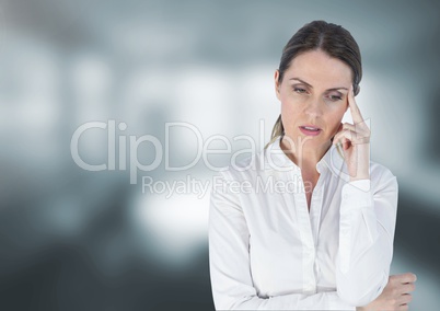Sad disappointed businesswoman against blurred grey background