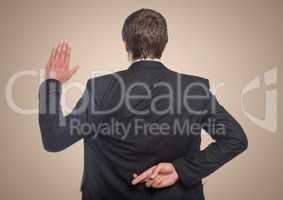 Back of business man with hand up and fingers crossed against cream background