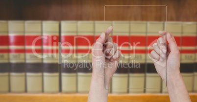 mans hands holding glass tablet in Library