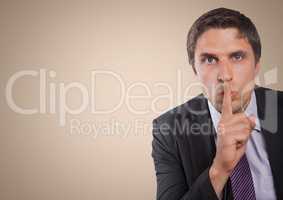 Business man finger over mouth against cream background