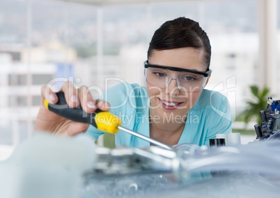 Woman with electronics in blurry office