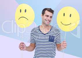 Man holding happy and sad face against blue background