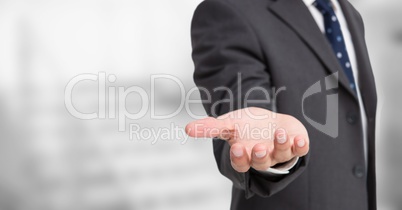 Business man mid section with hand out against blurry grey stairs