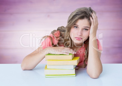 Woman with books at desk against blurry purple wood panel