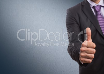 Business man mid section giving thumbs up against navy background