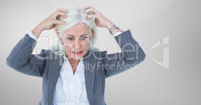 Stressed older woman against grey background