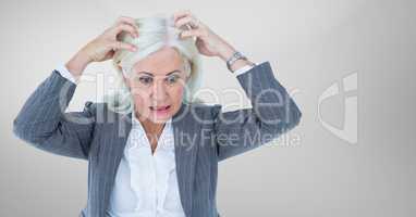 Stressed older woman against grey background