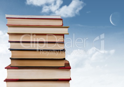 Books stacked by blue sky