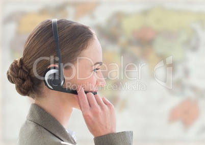 Close up of travel agent with headset against blurry map