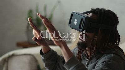 Man with virtual reality headset playing video games