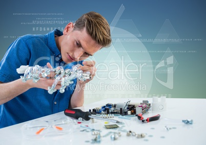 Man with electronics against blue green background with white interface