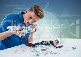 Man with electronics against blue green background with white interface