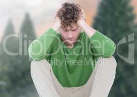 Depressed upset man against trees