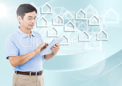 Man with tablet and flare against white house graphics and blue background