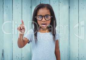 Girl with glasses against blue wood panel