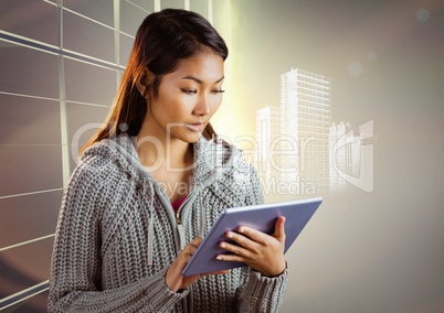 Woman with tablet and white building graphic against window evening sky