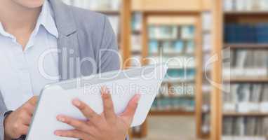 Womans hands on tablet in Library