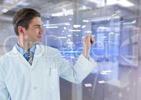 Man in lab coat holding up glass device against blue interface and blurry lab