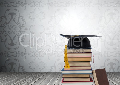 Books stacked by decorative wallpaper