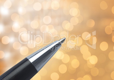 Pen tip against sparkles glow lights