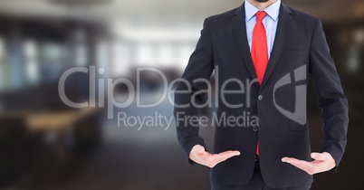 Business man mid section with palms up in blurry room