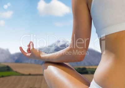 Woman Meditating by mountains